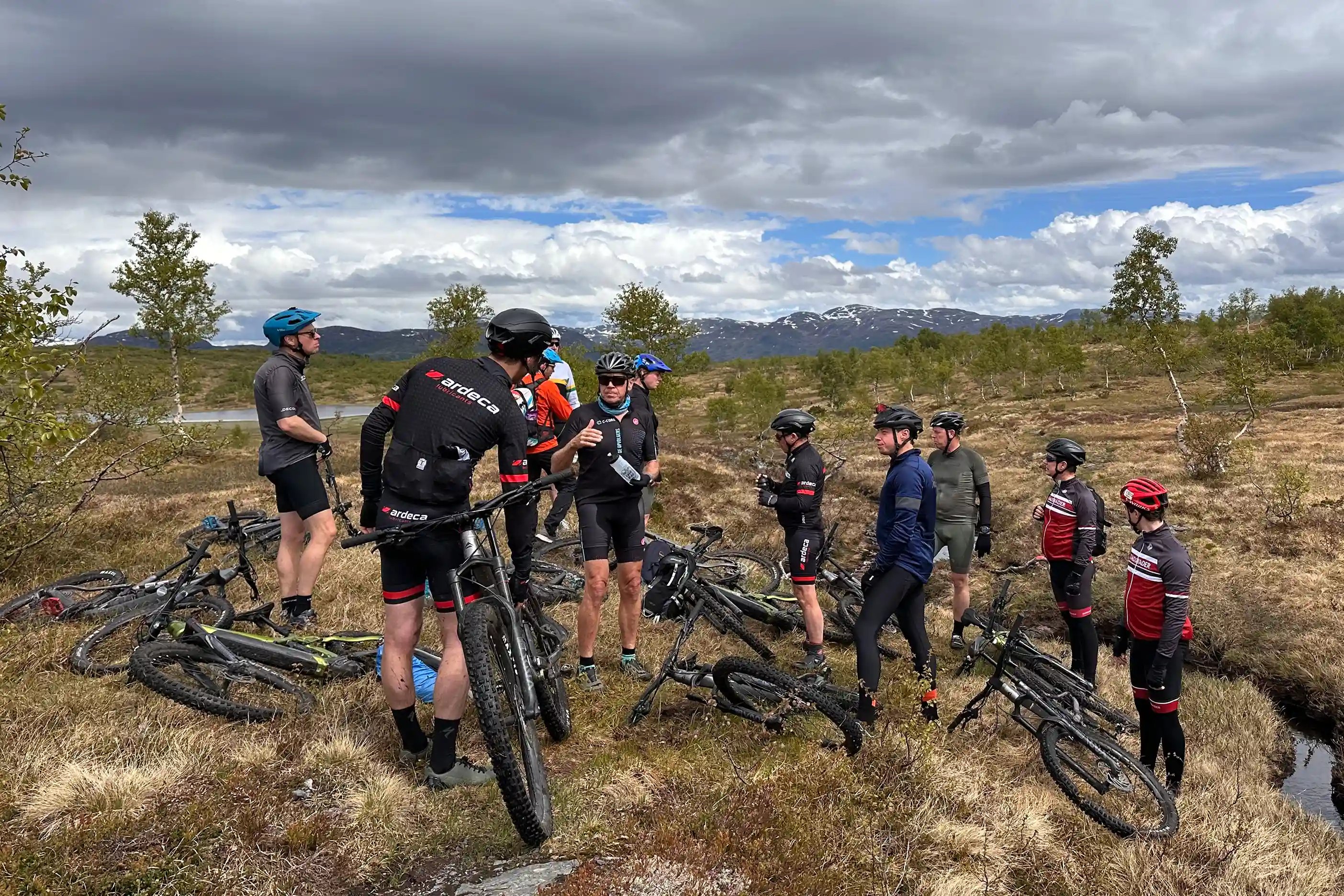 Group of mountain bikers on a guided traverse near Voss, Fjord Norway