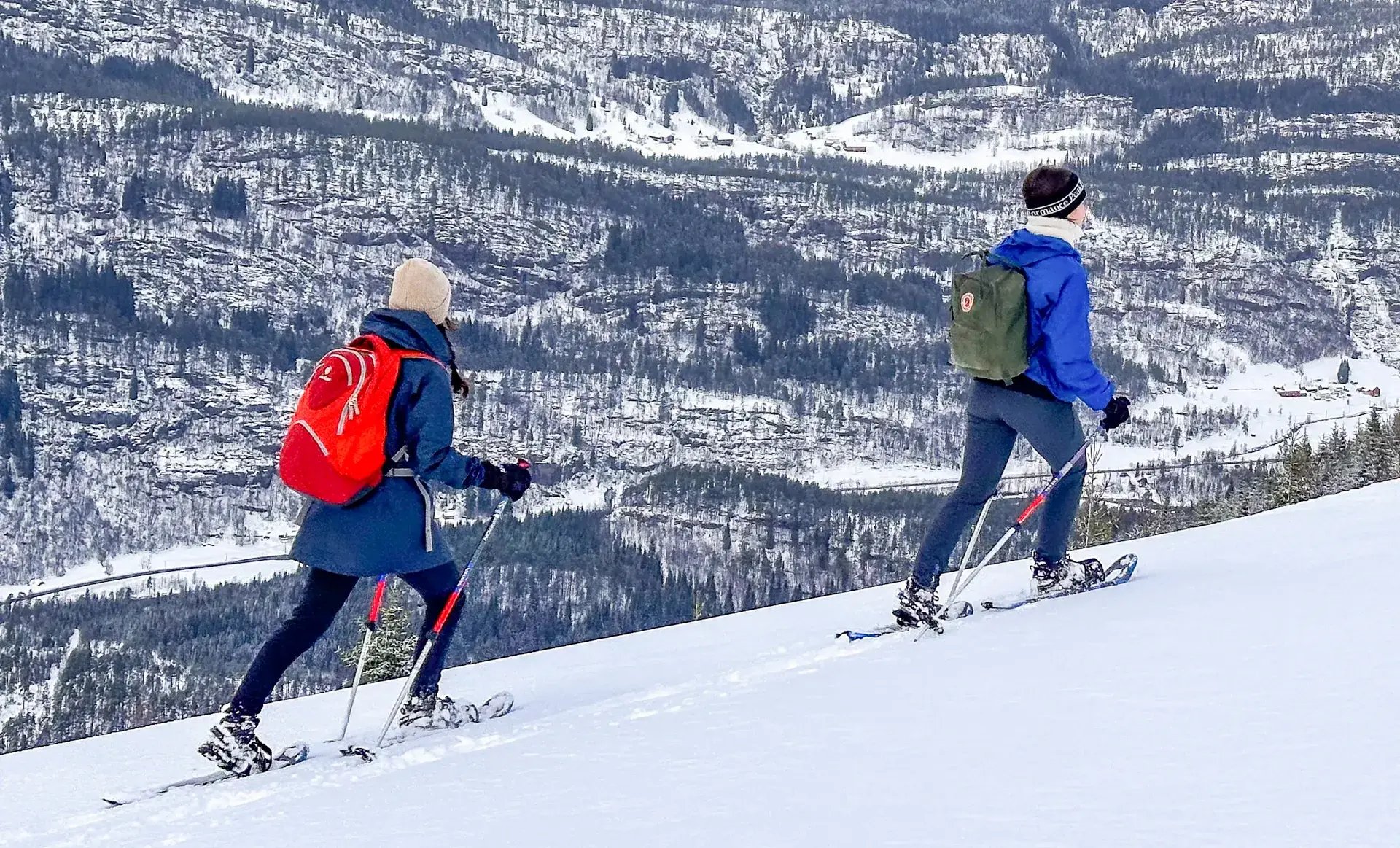 Two snowshoers with backpacks in Voss, Norway