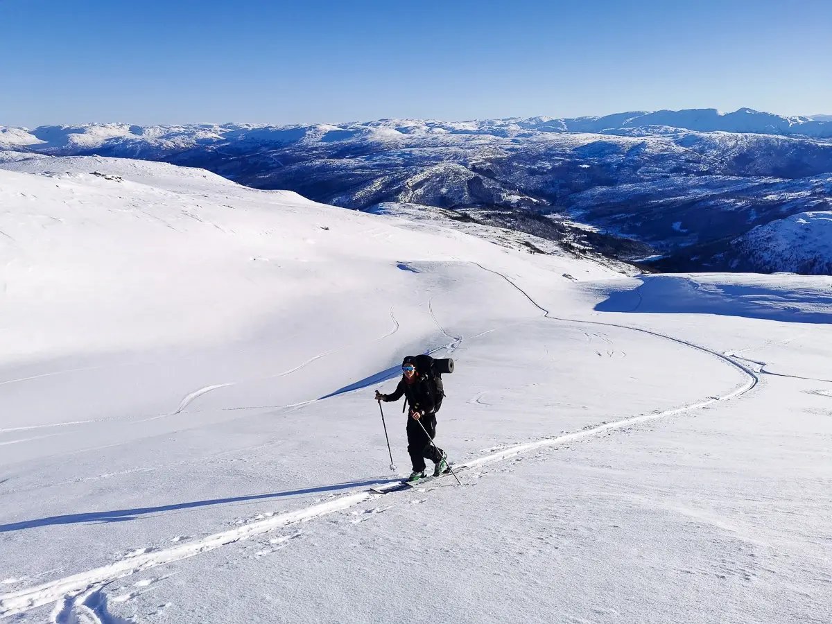 Backcountry skier in black jacket skiing off-piste in Voss, Norway