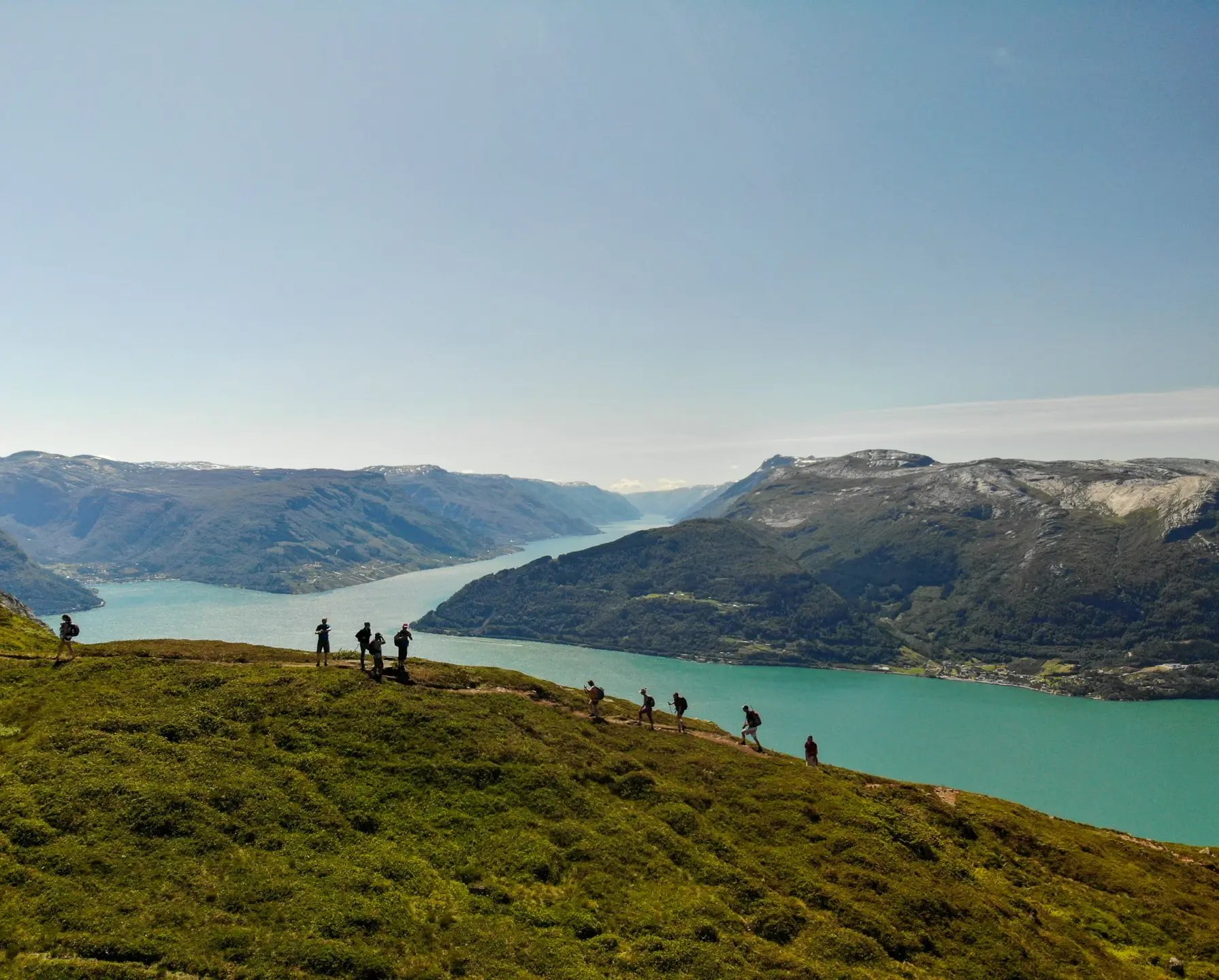Hikers on Mount Oksen taking photos of the landscape, one of the best attractions in Voss, Norway