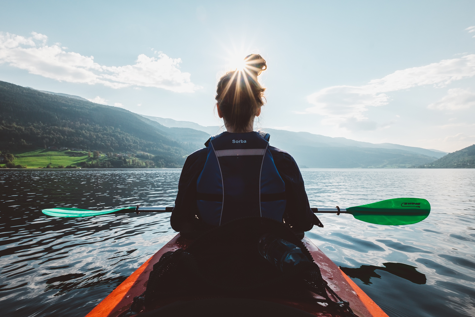A woman kayaking in the Hardangerfjord area in Voss, Norway