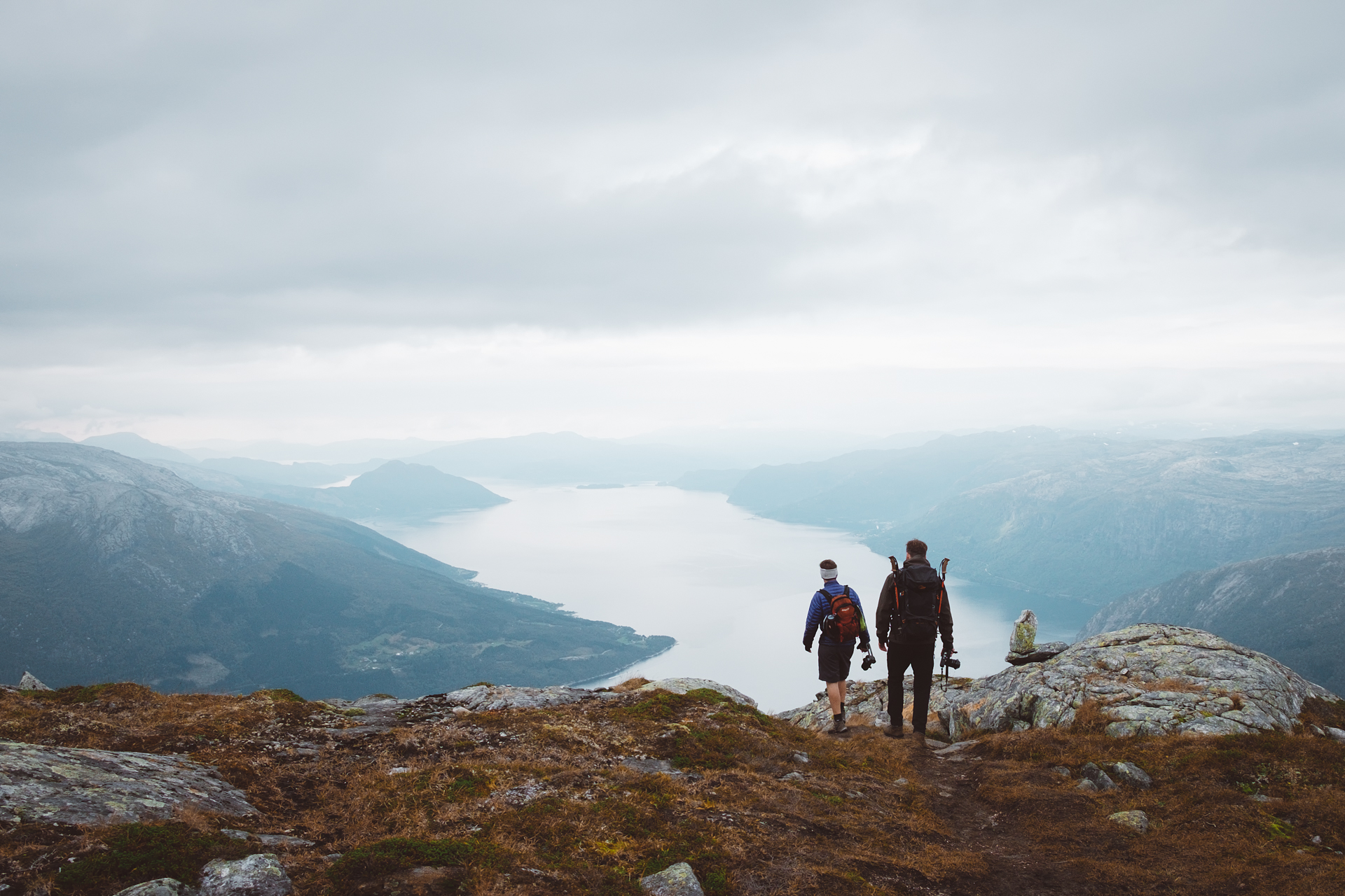 Hikers admiring Hardangerfjord, Norway from above near Voss