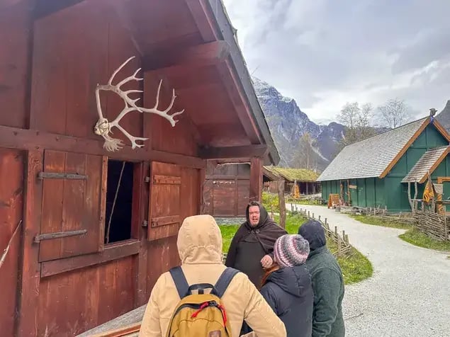 Group of tourists in an ancient Viking village in FJord Norway