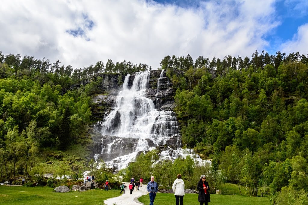 Tvindefossen waterfall and tourists taking photos of one of the best things to do in Voss, Norway