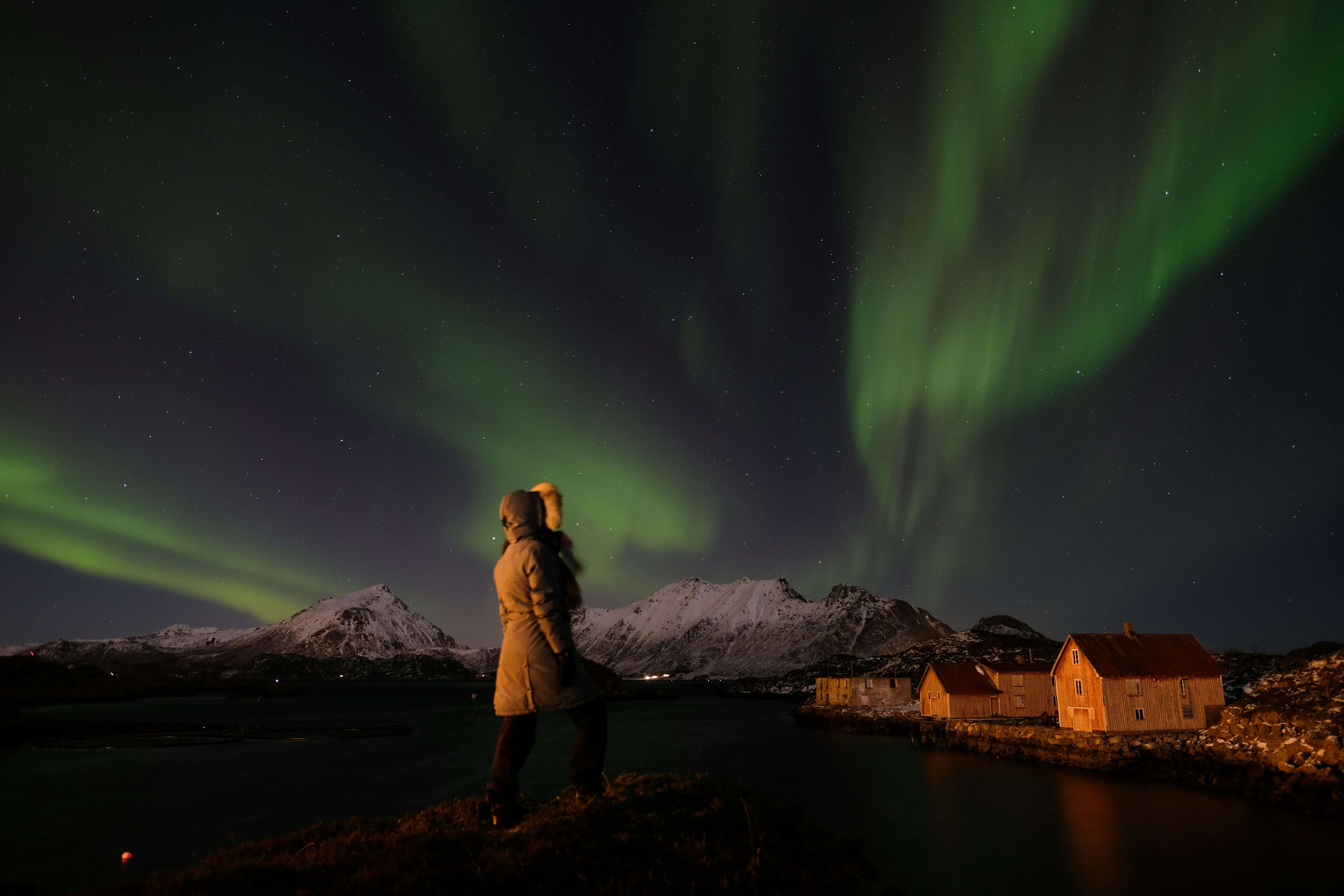 A woman looking at Northern Lights in Norway