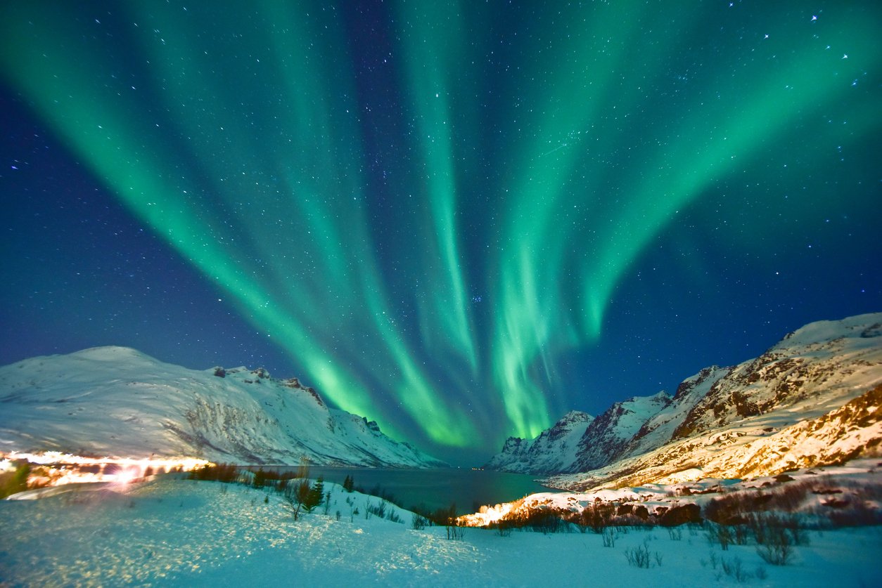 A view of the Northern Lights above a lake in Lofoten, Norway