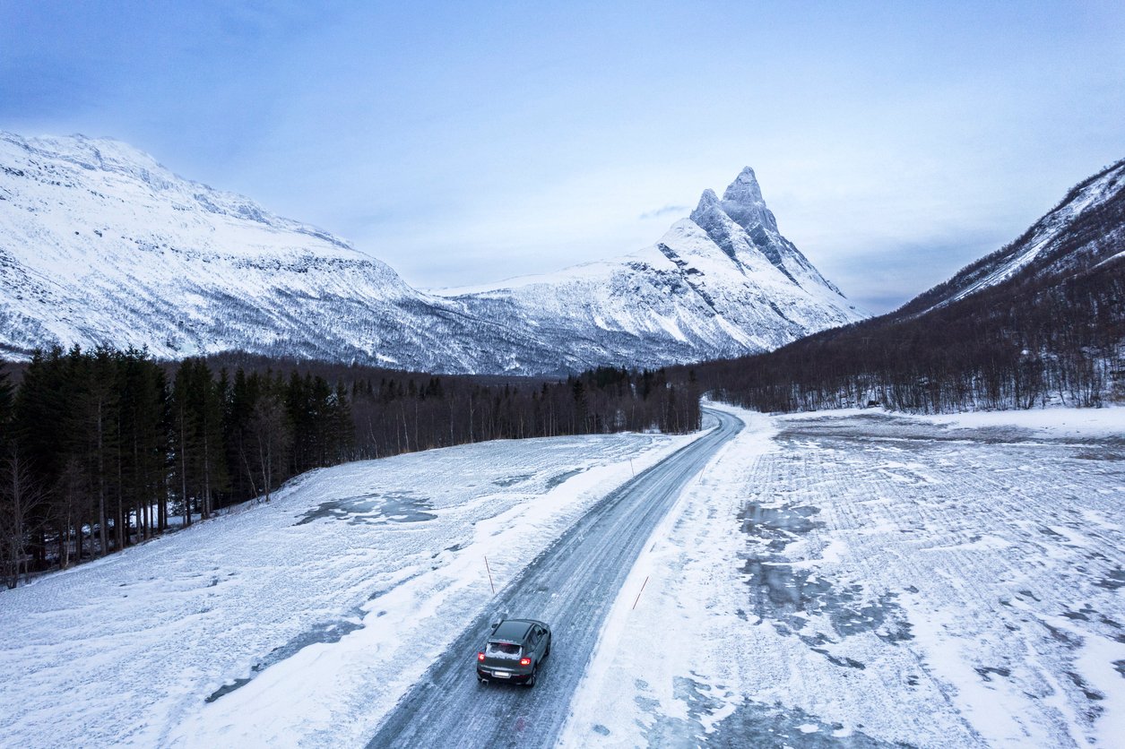 A car on a mountain road in Norway in the winter