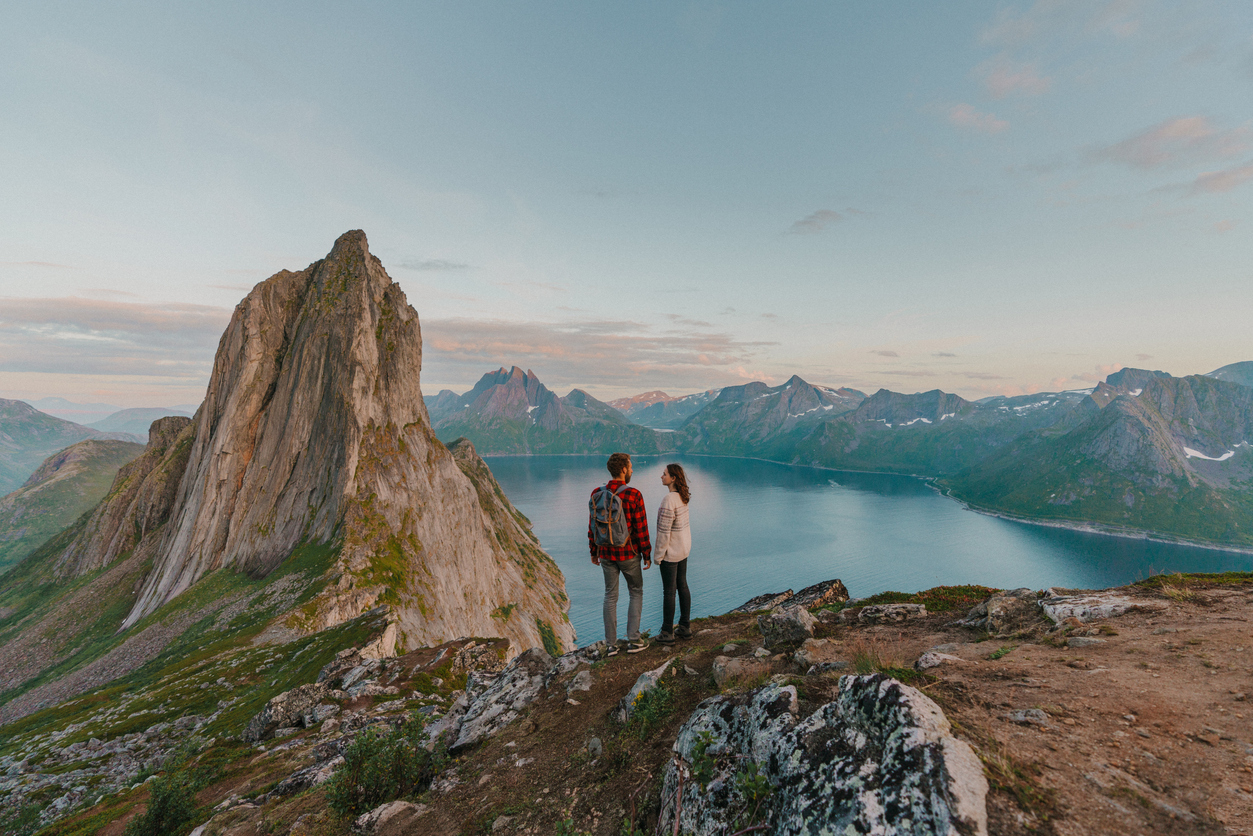 A couple posing atop of Senja Island in Norway
