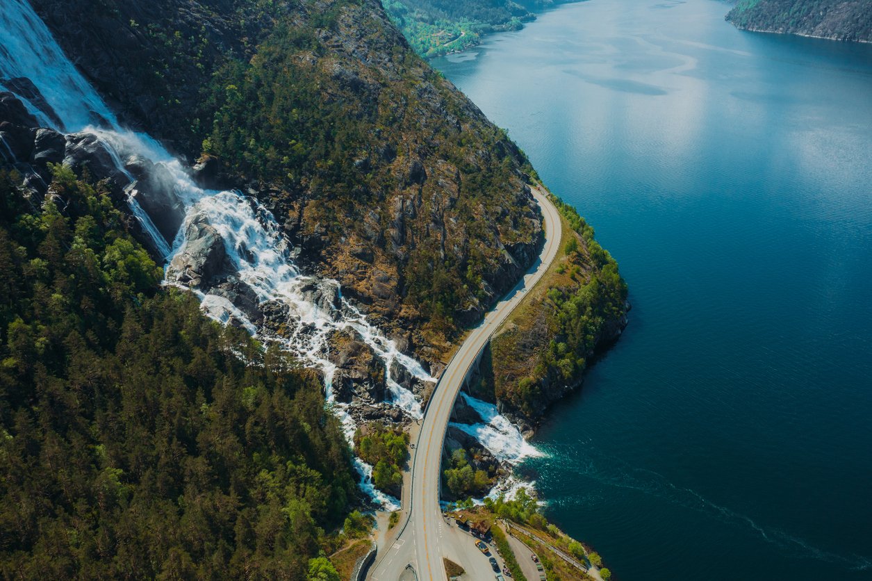hardangerfjord scenic road passing by a waterfall, overhead view