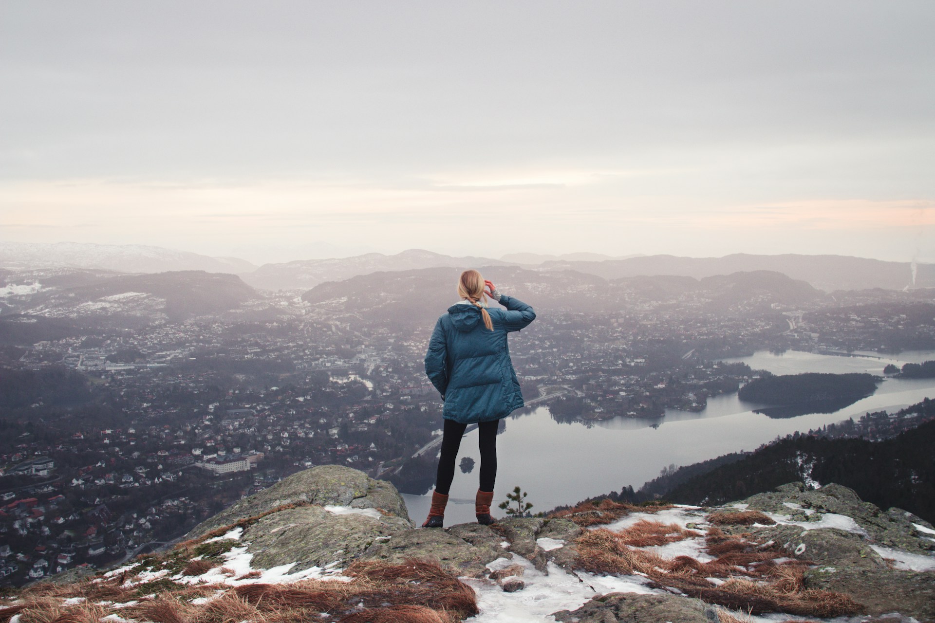 Hiker standing above Bergen in early spring weather