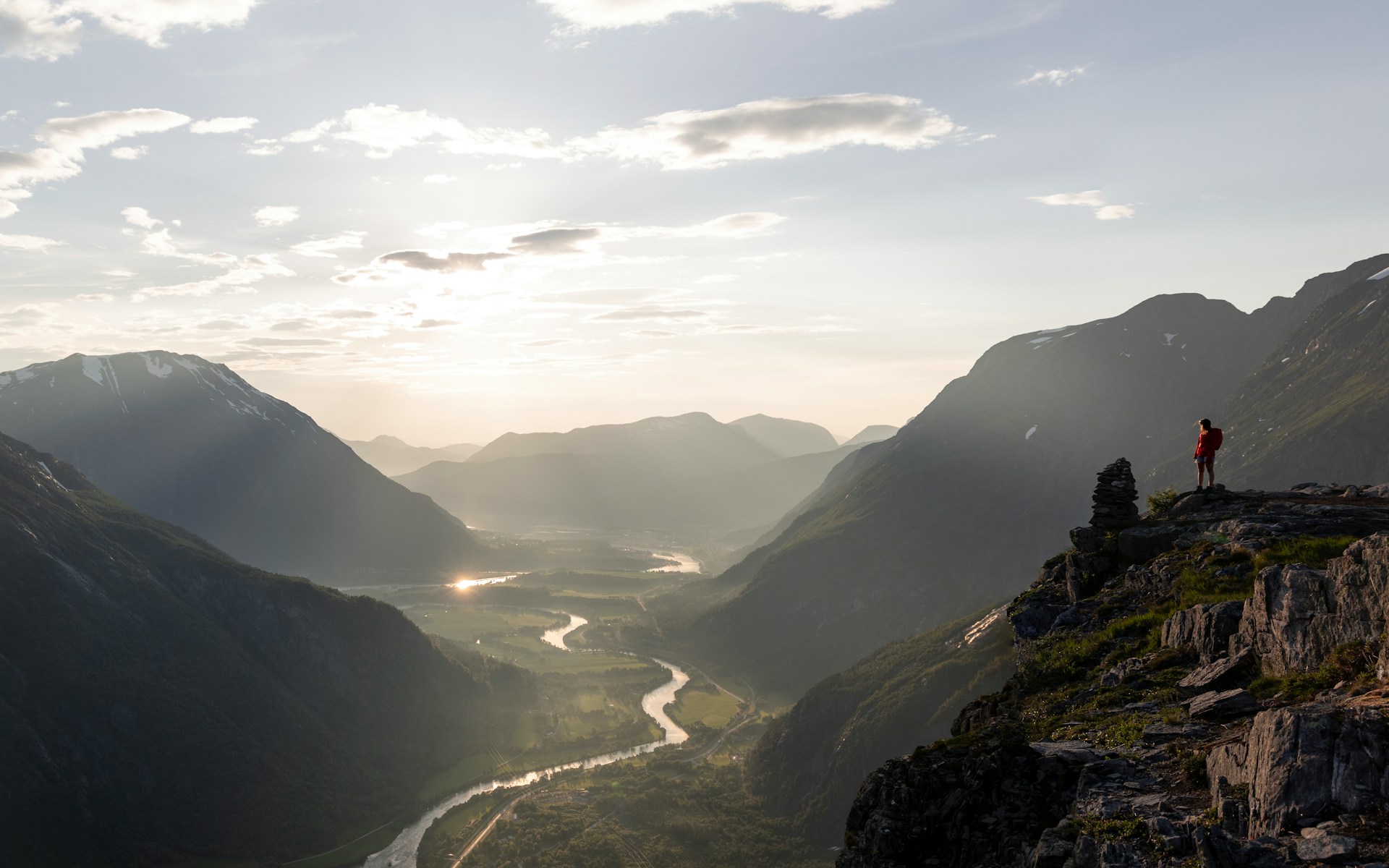 Hiker watching the sunset after walking one of the best hikes in Norway
