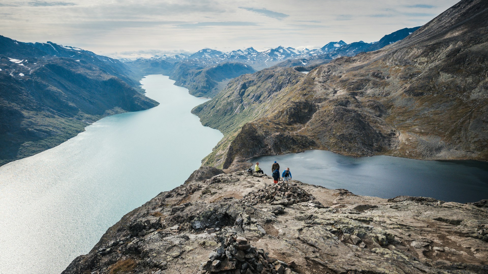 Hikers in a group walking alongside Besseggen, one of the best ridgeside hikes in Norway