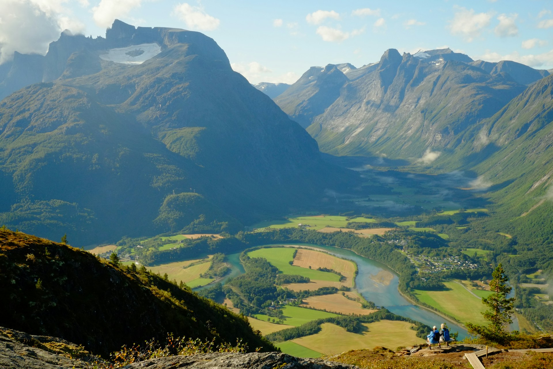 Hikers resting on the Romsdalseggen hiking trail towards Andalsnes, Norway