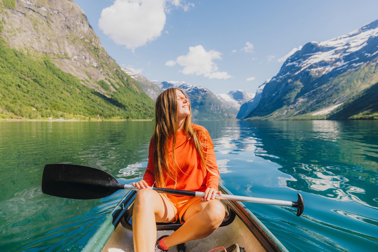 Woman exploring the Fjords of Norway by kayak, one of the things the country is most famous for