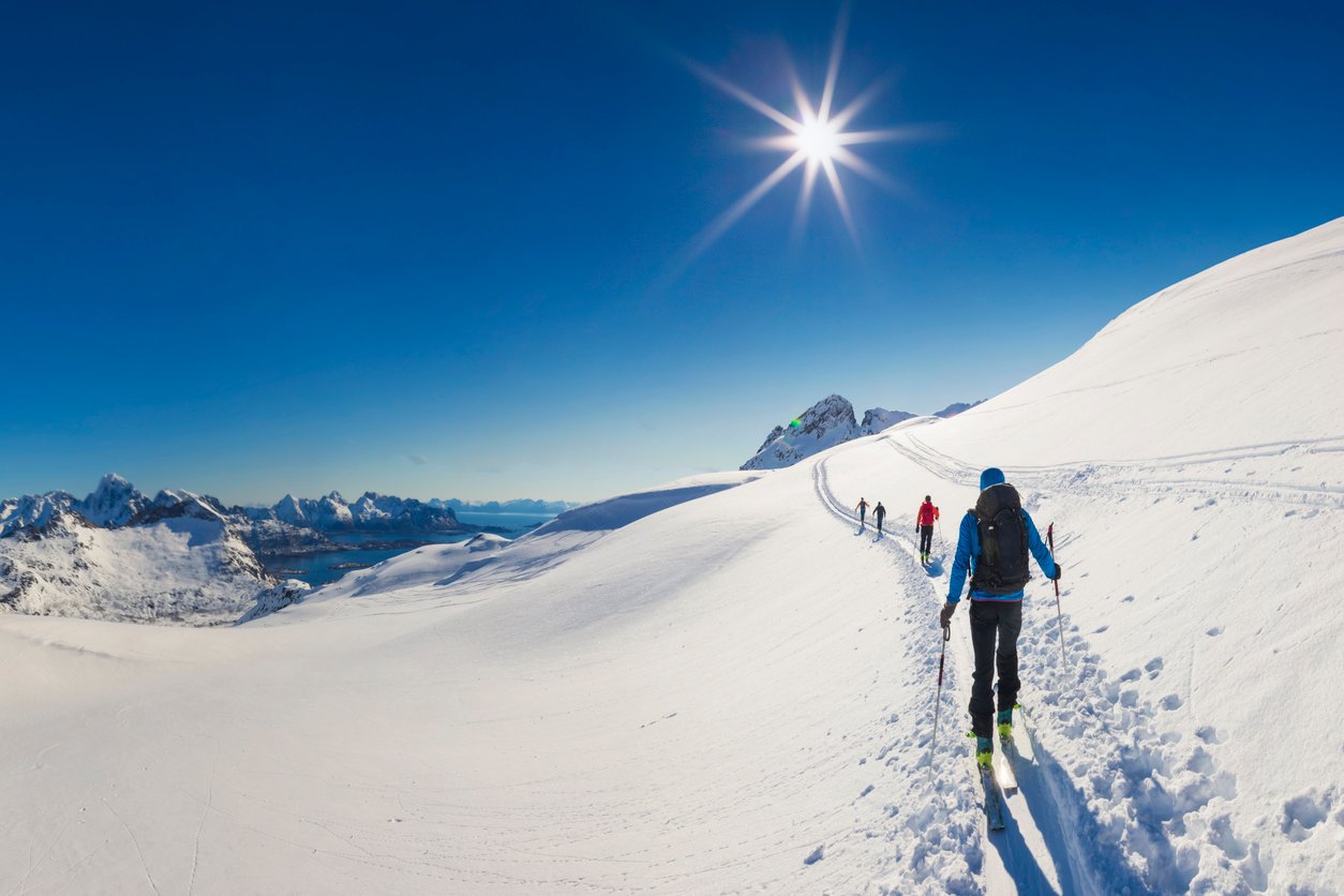 Skiers touring through the winter landscapes of Lofoten, Norway