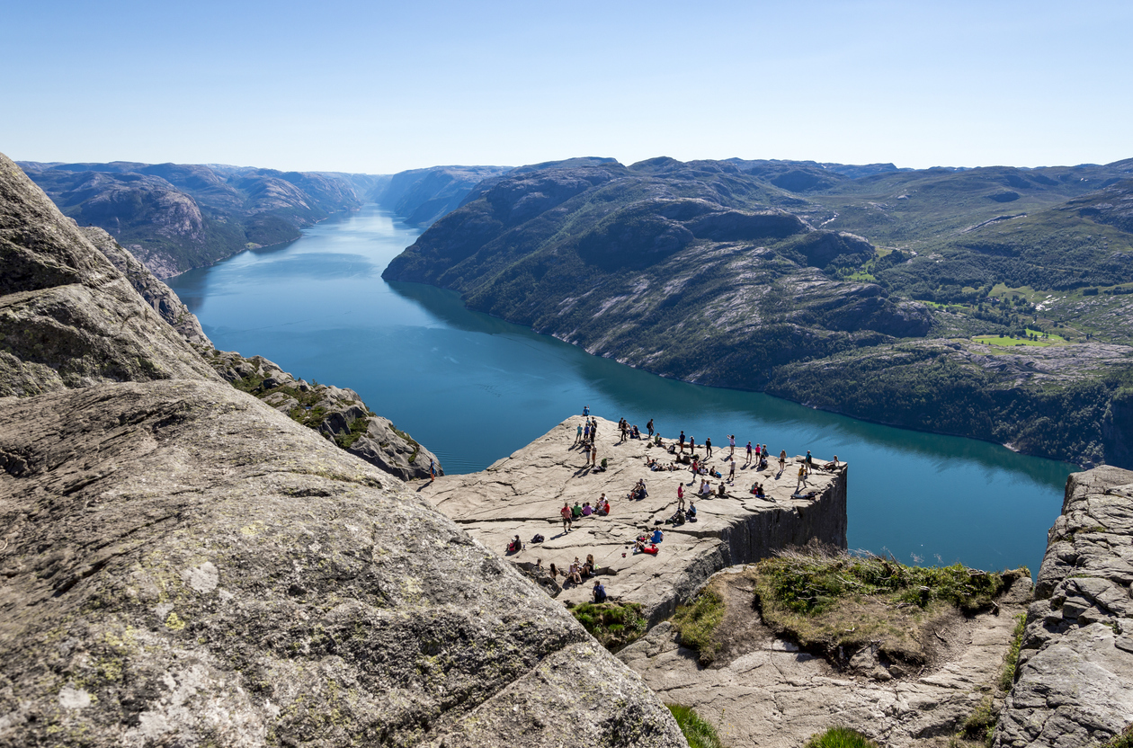 A group of tourists exploring Pulpit Rock in Lysefjord, a hike in one of the most beautiful places in Norway