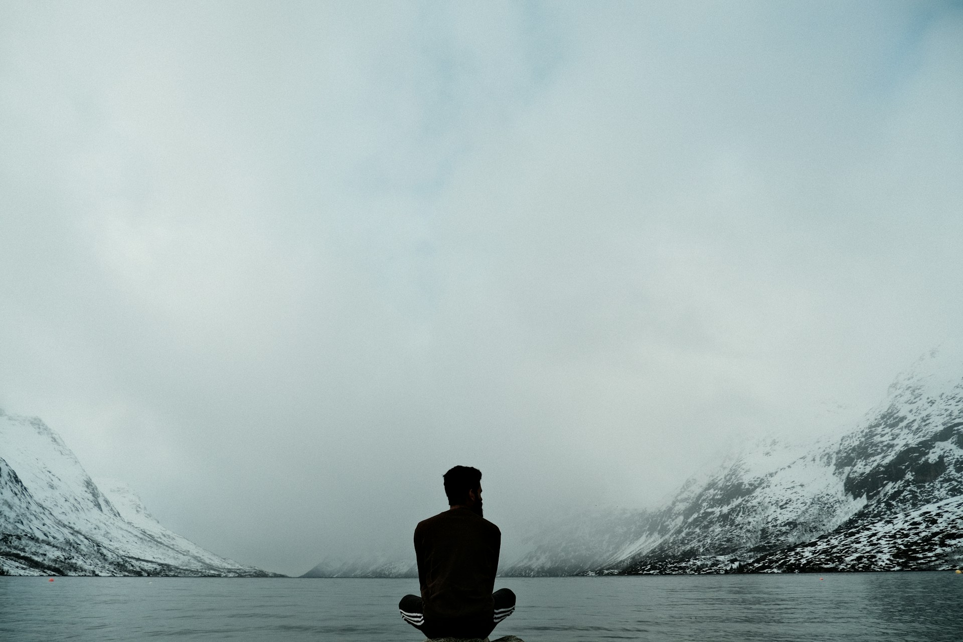 A man admiring Norway's fjords in the autumn