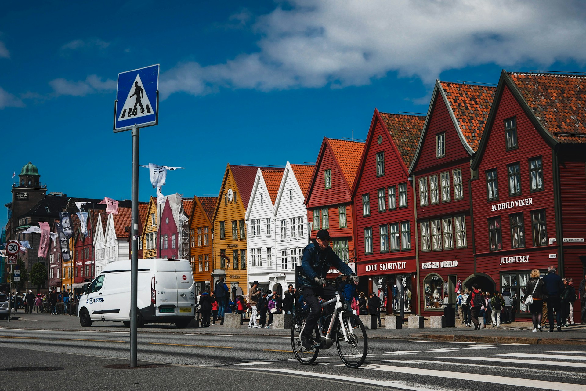 A local man cycling around Bergen in a winter jacket