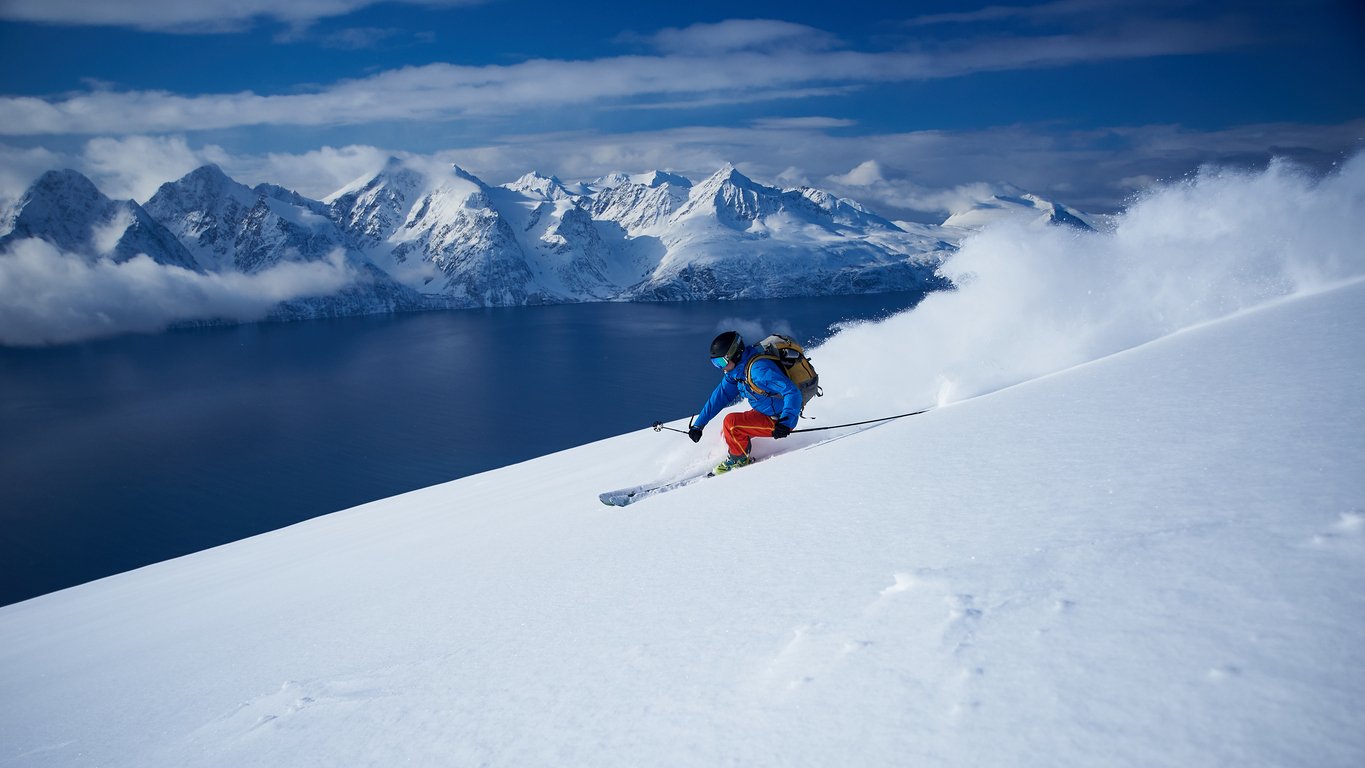 A man skiing Lyngenfjord in the Lyngen Alps, Northern Norway Fjord