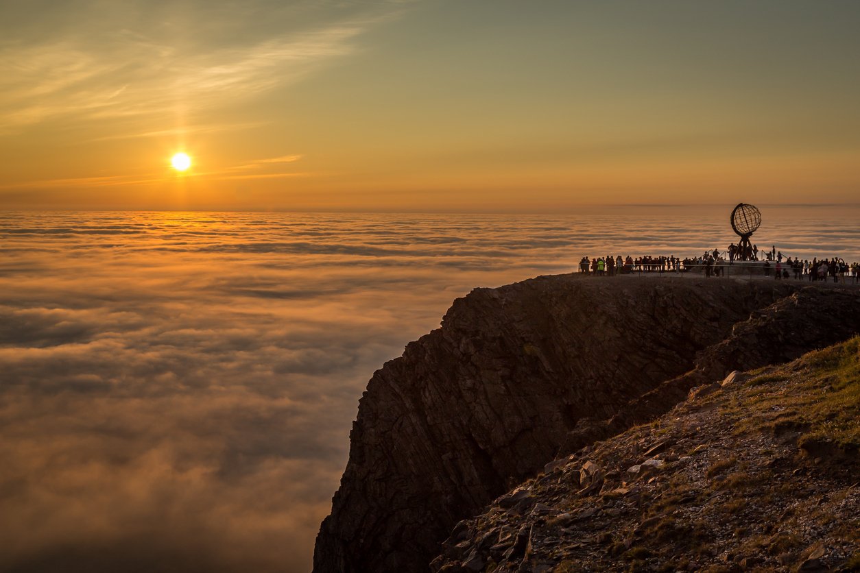 The Midnight Sun with onlookers in Northern Norway