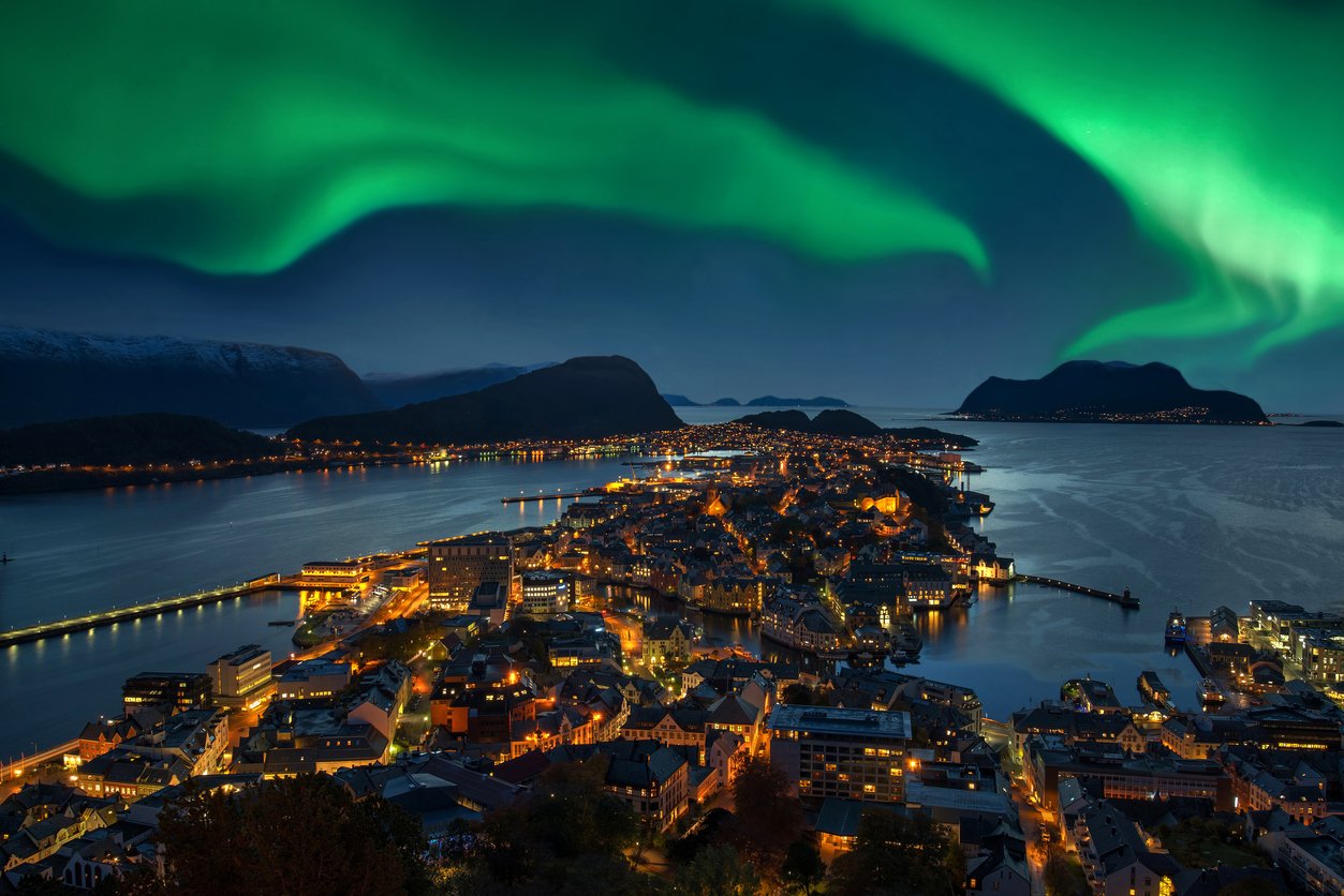 A view of the Northern Lights from Alesund, Norway as the background