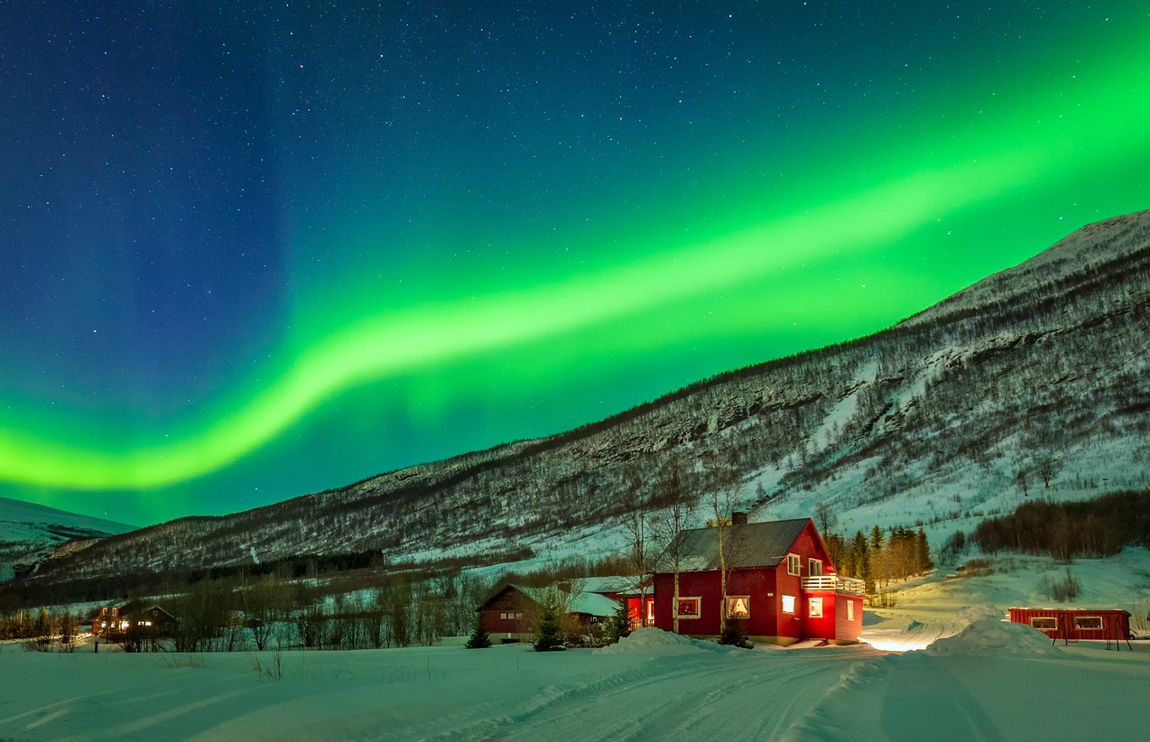 Northern Lights above the colorful countryside near Tromso