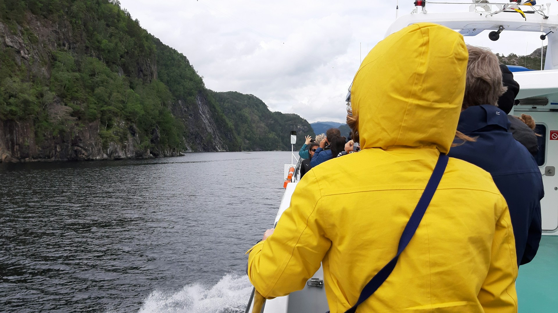 Tourists exploring the Norway fjords by boat on an organized cruise