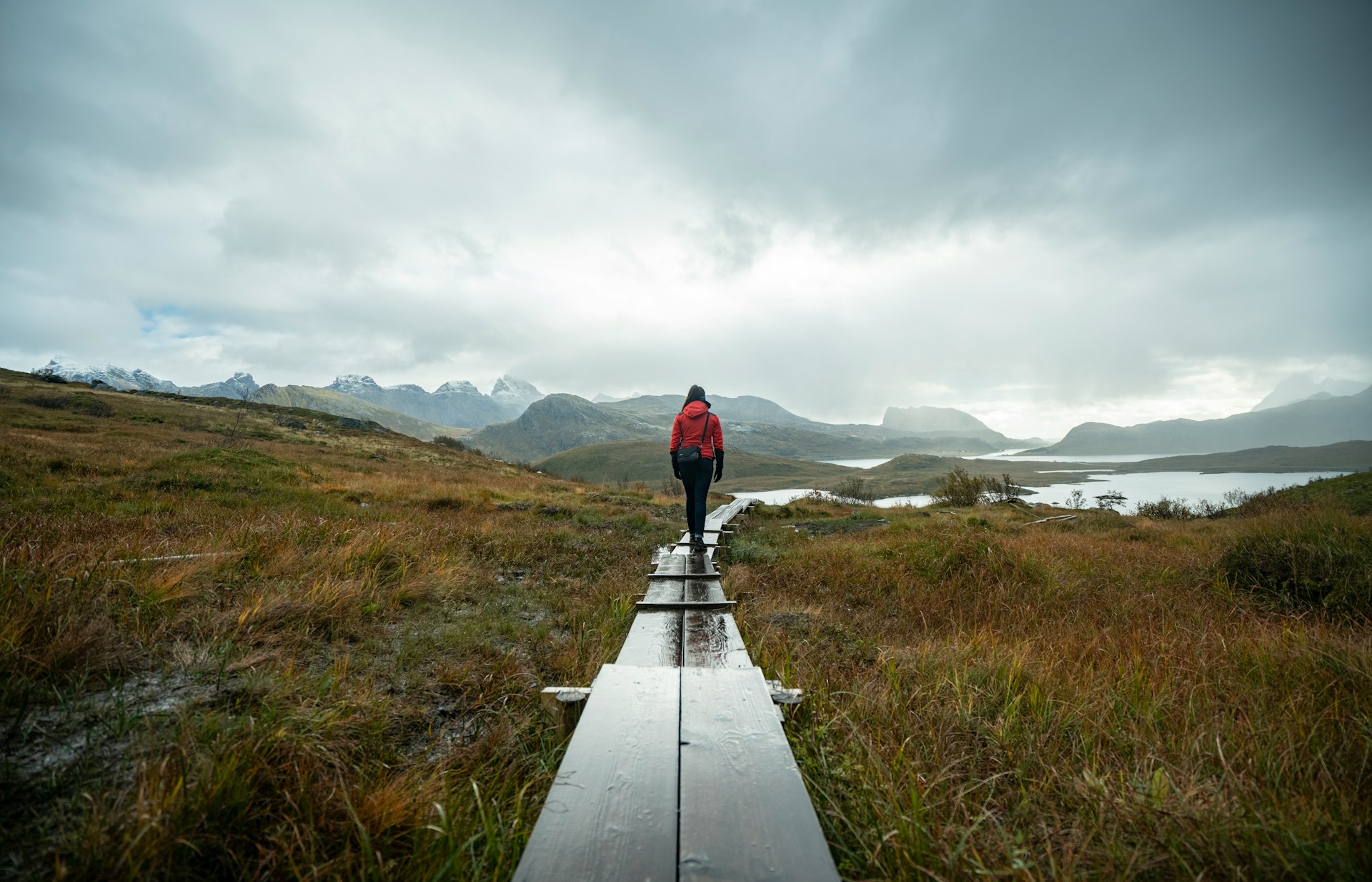 Hiker on a wooden trail on one of the best hikes in Norway