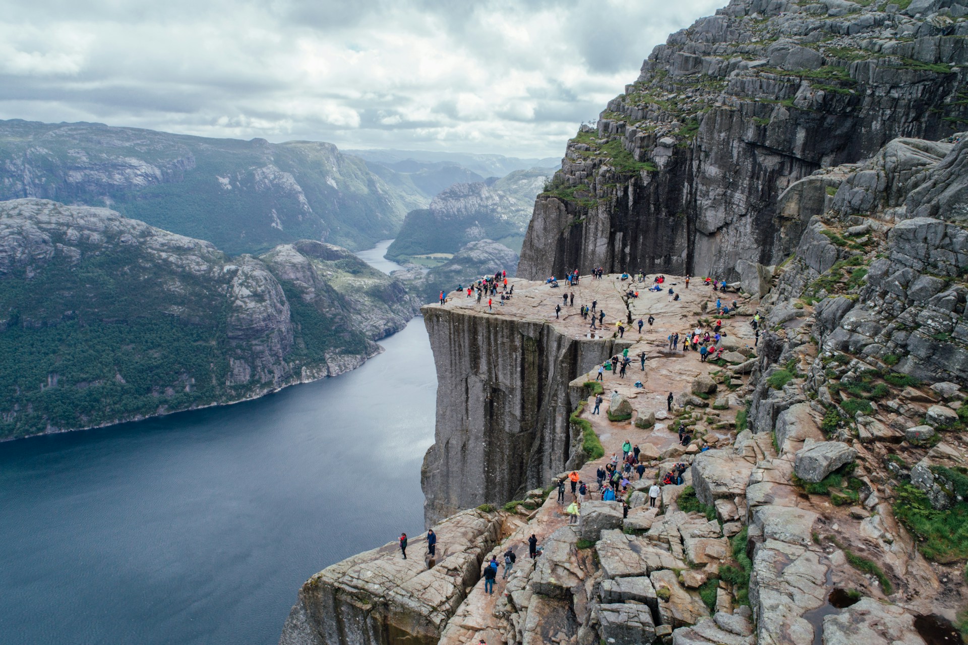 Tourists exploring Prekiestolen, crowded area in Norway