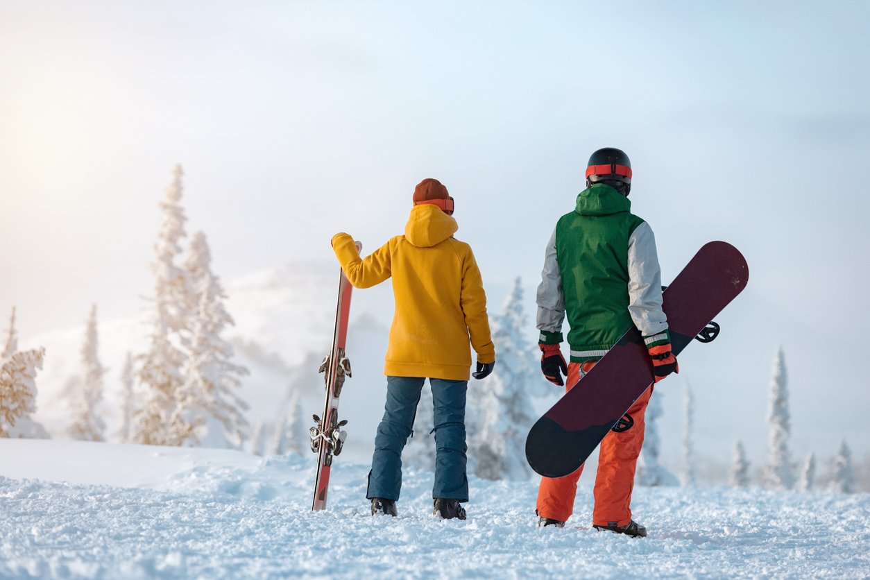 A skier and a snowboarder on a fjord in the Voss area