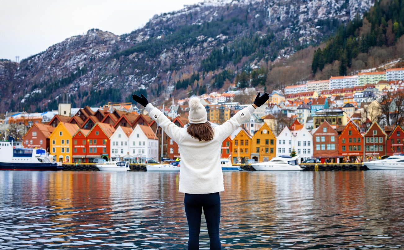 A tourist enjoying the vistas of the Bryggen UNESCO area in Bergen, Norway