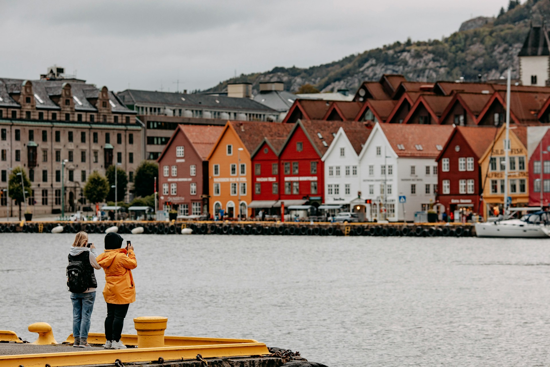 Tourists taking photos of Bergen, Norway's Bryggen district in SEptember
