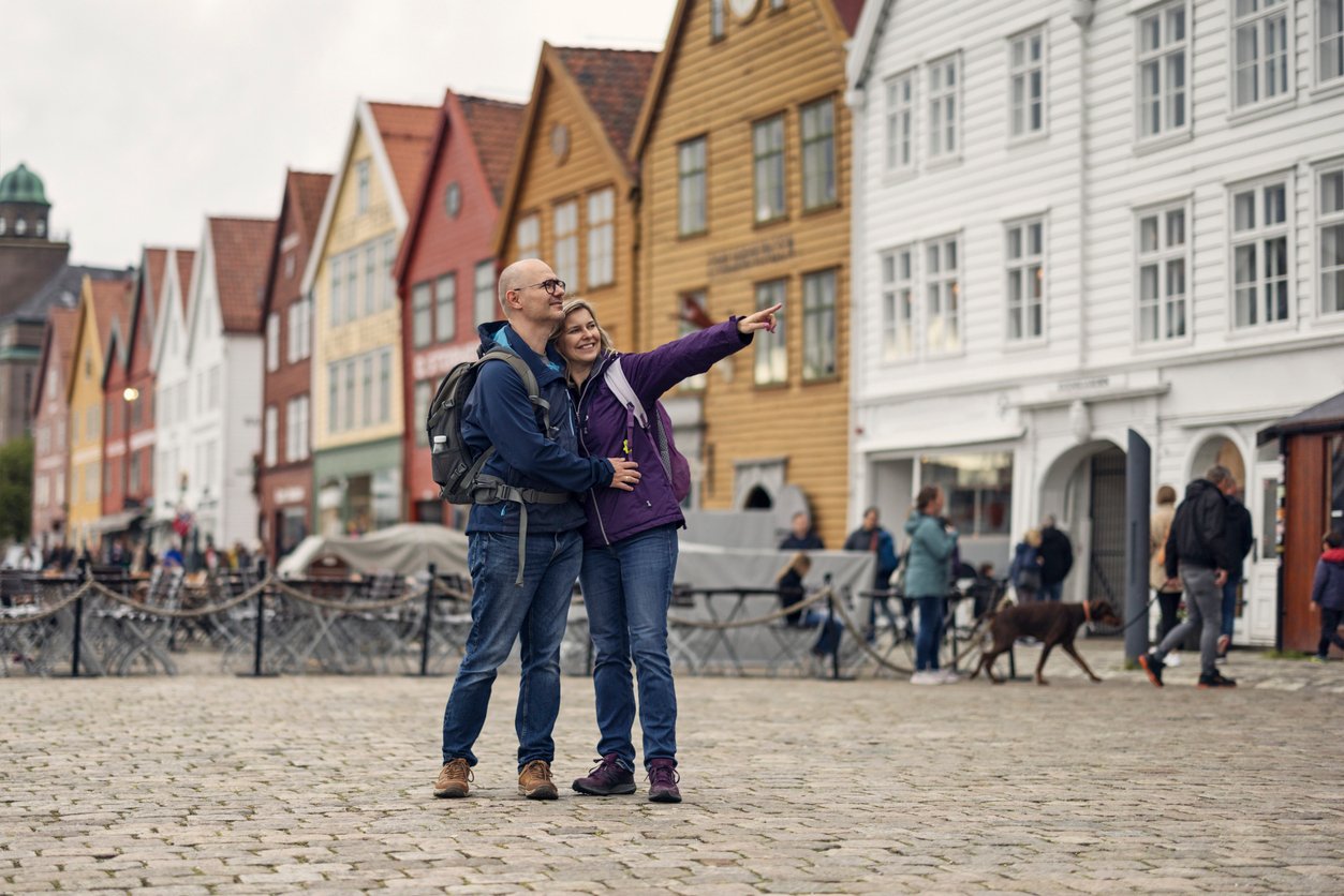 Tourists exploring Bryggen in Bergen, Norway