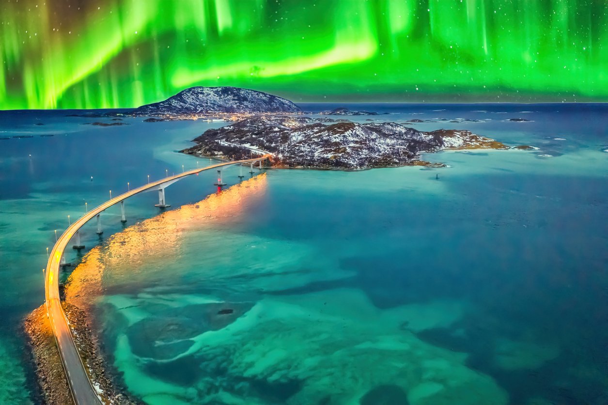 Northern Lights above a sea road leading to Tromsø, Norway, from the Tromsø Airport
