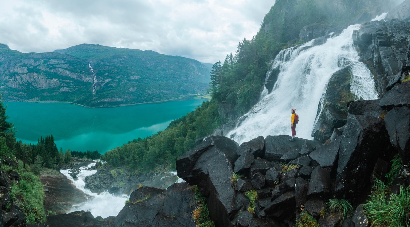 A woman hiking near Folgefonna near a waterfall