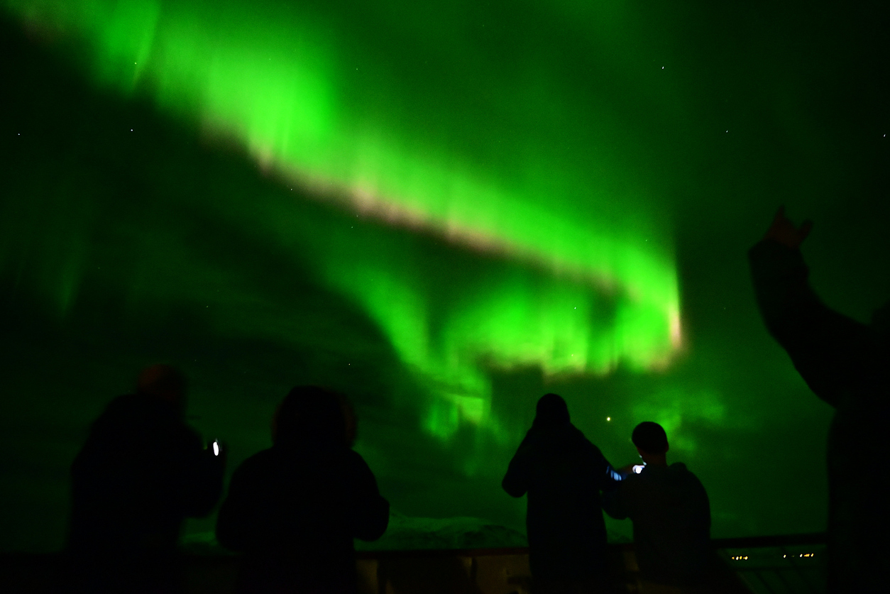 people-admiring-northern-lights-norway